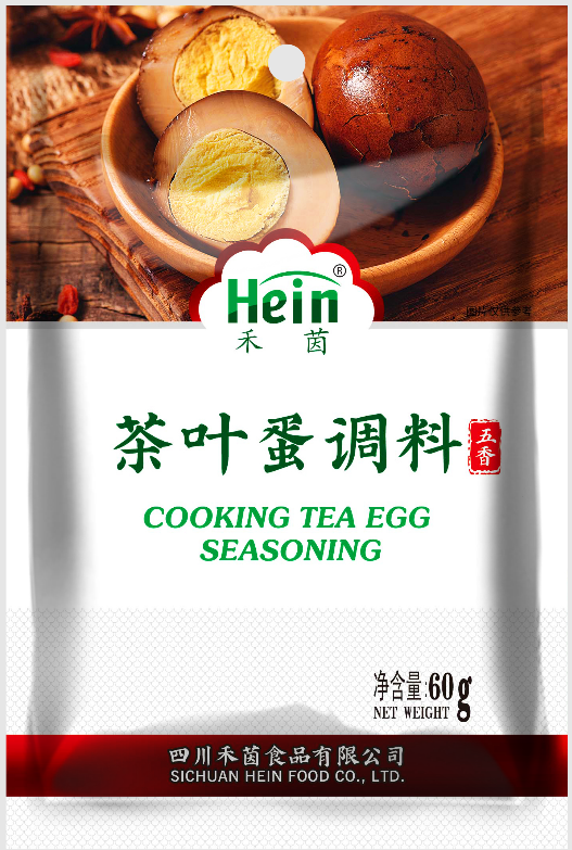 Packaging of Hein cooking tea egg seasoning with tea eggs on a wooden surface