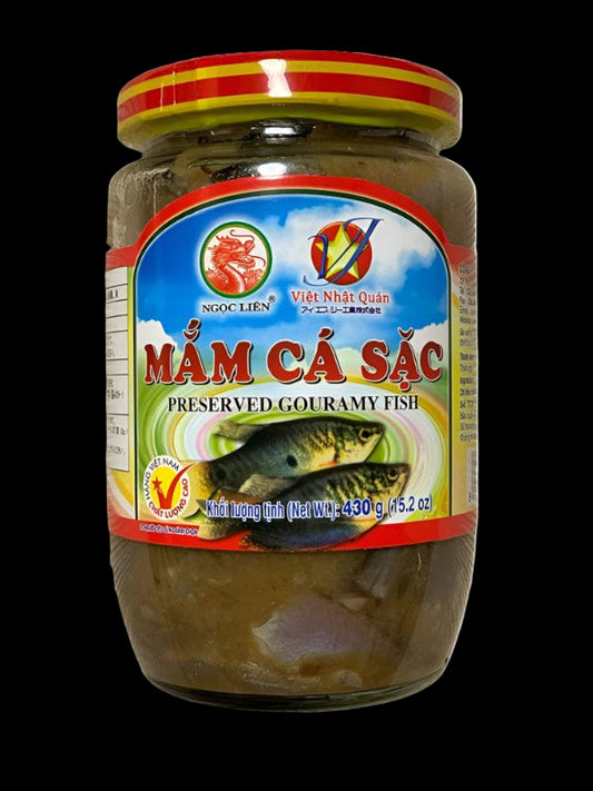 Jar of preserved gouramy fish with a colorful label