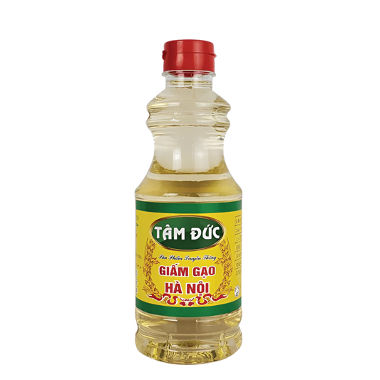 Bottle of Tam Duc rice vinegar with a yellow label on a white background